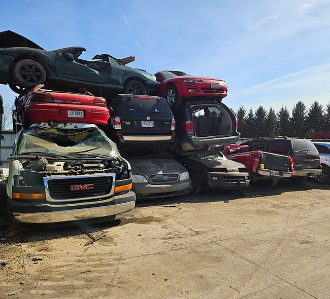 Car Wreckers Otago yard with stacked old and scrap cars ready for dismantling and recycling